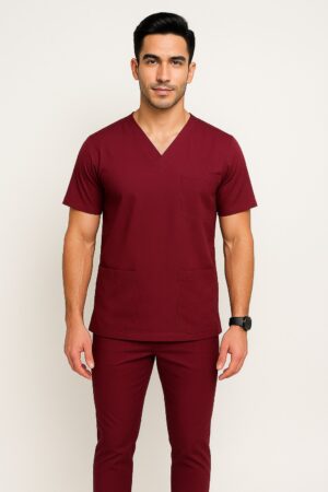 Male model wearing slim fit navy medical scrub suit with V-neck top and matching tapered pants.